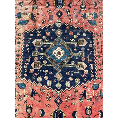 330 - Middle Eastern/Moroccan design hand woven red ground carpet, with central medallion, repeating styli... 