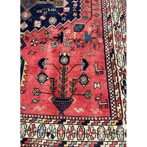 330 - Middle Eastern/Moroccan design hand woven red ground carpet, with central medallion, repeating styli... 