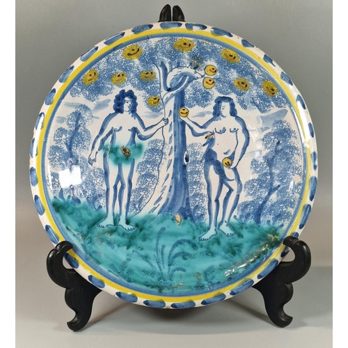 17th century English Delft pottery tin glazed 'Adam and Eve' dish, painted with the two figures under an apple tree polychrome decorated within a yellow banded dash border, possible Bristol. 30cm diameter approx. (B.P. 21% + VAT)