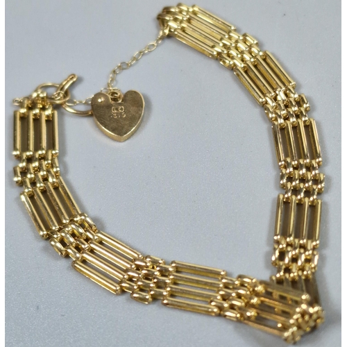 242 - 9ct gold four bar gate bracelet with heart shaped padlock. 9.1g approx. (B.P. 21% + VAT)