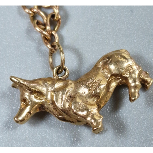 246 - 9ct gold curb-link charm bracelet, the two charms to include: harp and Corgi dog. 11.7g approx. (B.P... 