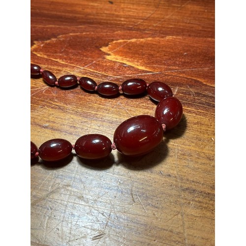 235 - 1930s Cherry Bakelite graduated beaded necklace. 50g approx. (B.P. 21% + VAT)