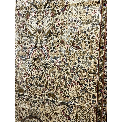 324 - Ivory ground full pile kasmir 'Tree of Life' design rug. 308x193cm approx.  (B.P. 21% + VAT)