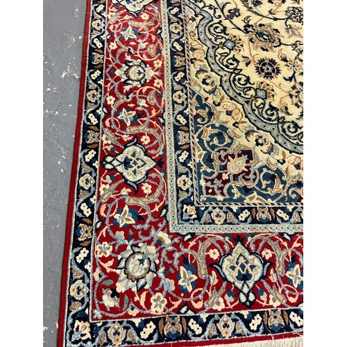 322 - Fine hand woven Persian Nian carpet with large central medallion design and flower and floral repeat... 