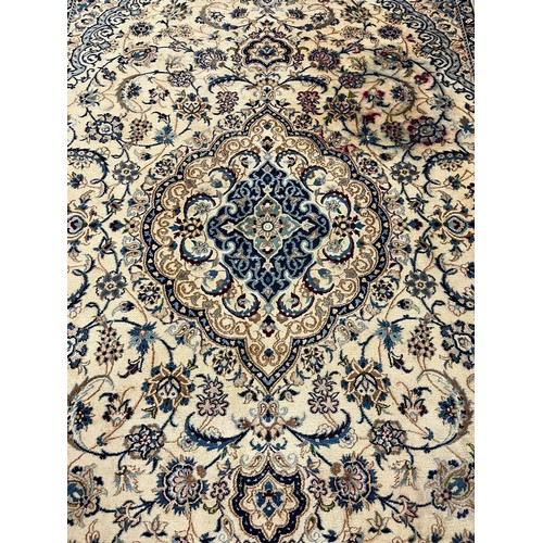 322 - Fine hand woven Persian Nian carpet with large central medallion design and flower and floral repeat... 