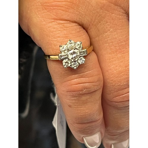 193 - 18ct gold and platinum diamond flowerhead ring, having seven brilliant round cut diamonds and two ba... 