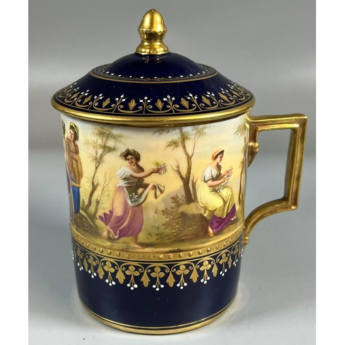 134 - Late 19th early 20th century Vienna porcelain chocolate cup and cover on a gilded and cobalt blue gr... 