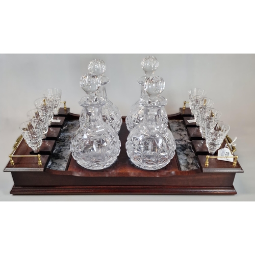 104 - Reproduction mahogany and brass two handled decanter tray, featuring a collection of four baluster s... 