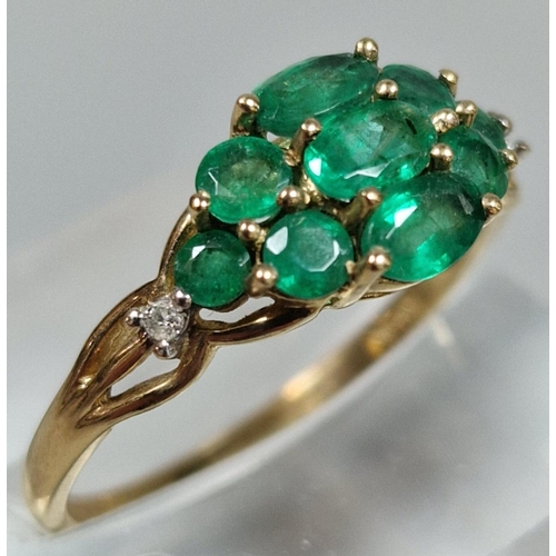 324 - 9ct gold multi-cluster green stone dress ring, inset with two tiny diamond chips. 2g approx. Size Q.... 