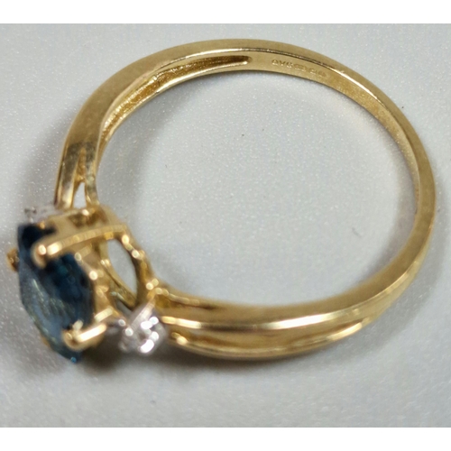 326 - 9ct gold and blue stone dress ring inset with two tiny diamond chips. 2g approx. Size R.  (B.P. 21% ... 