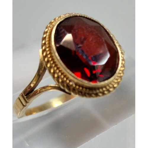 327 - 9ct gold red stone dress ring. 2.7g approx. Size J.  (B.P. 21% + VAT)