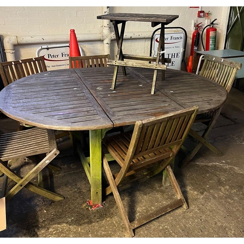 643 - Teak oval extending garden table with a group of five similar (not all matching) chairs and a foldin... 