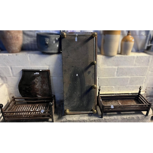 649 - Two fireplace dog grates, a cast iron Fleur De Lys arched fire back, a deep fire fender and hearth. ... 