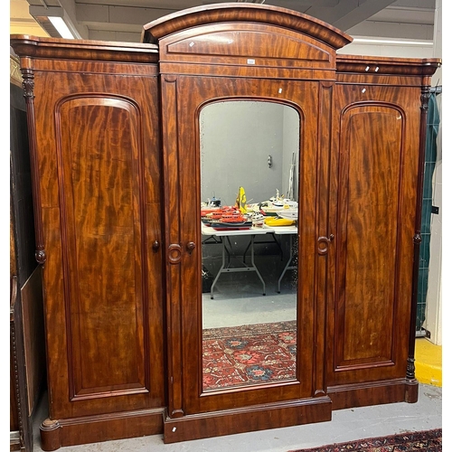 654 - Victorian mahogany break front wardrobe, having arched pediment over centre glazed door revealing fi... 