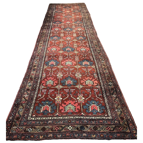 658 - Hand made Persian Tabriz red ground runner with repeating geometric patterns. 490x132cm approx. (B.P... 