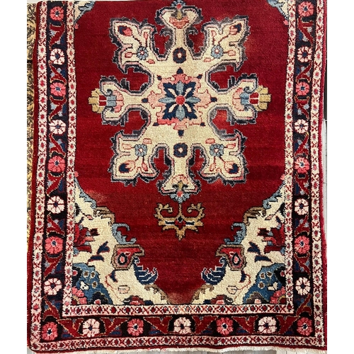 667 - Rich red ground hand woven Persian Village rug with medallion design. 203x120cm approx.  (B.P. 21% +... 