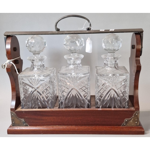 98 - Three bottle mahogany and silver plated tantalus, marked PB & S. With key.  (B.P. 21% + VAT)