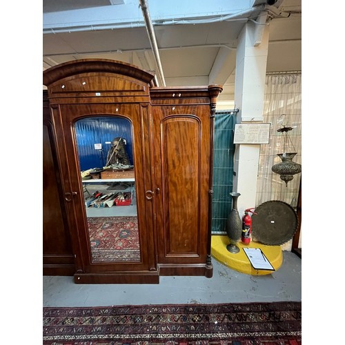 654 - Victorian mahogany break front wardrobe, having arched pediment over centre glazed door revealing fi... 