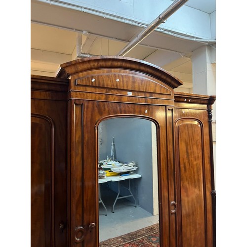 654 - Victorian mahogany break front wardrobe, having arched pediment over centre glazed door revealing fi... 