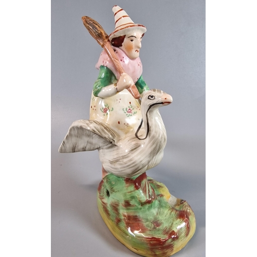 12 - 19th century Staffordshire pottery figure group of a Witch riding a Goose. 19cm high approx. Togethe... 