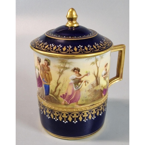 18 - Late 19th early 20th century Vienna porcelain chocolate cup and cover on a gilded and cobalt blue gr... 