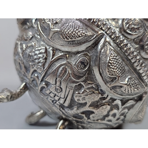 197 - Indian white metal footed bowl, repoussé decorated with Indian figures, flowers and foliage. 10cm di... 