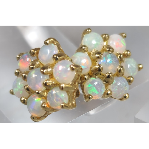 226 - Two similar pairs of opal cluster earrings, one marked 9ct gold the other RG. (B.P. 21% + VAT)