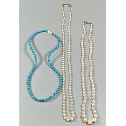 244 - Two graduated pearl necklaces, one with white metal and diamond clasp, the other yellow metal clasp.... 