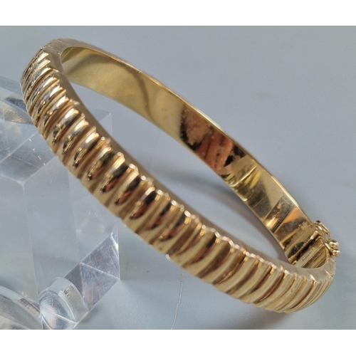 245 - 9ct gold ladies' bangle of ribbed form. 19.3g approx.(B.P. 21% + VAT)