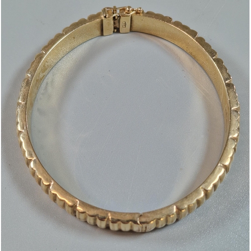 245 - 9ct gold ladies' bangle of ribbed form. 19.3g approx.(B.P. 21% + VAT)