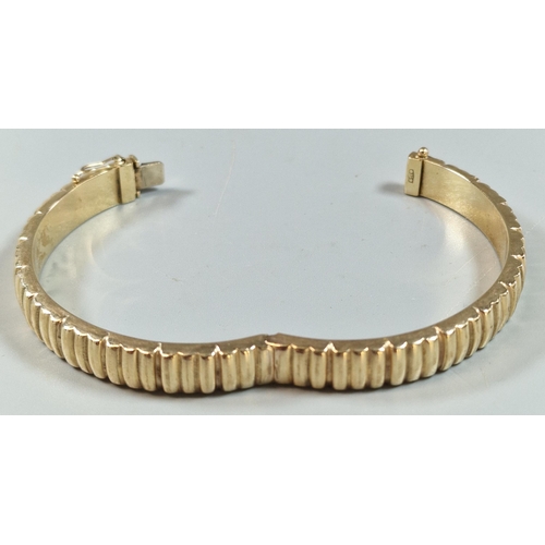 245 - 9ct gold ladies' bangle of ribbed form. 19.3g approx.(B.P. 21% + VAT)