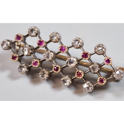 250 - White metal diamond and ruby bar brooch, featuring twenty four stones with repeating design, in leat... 