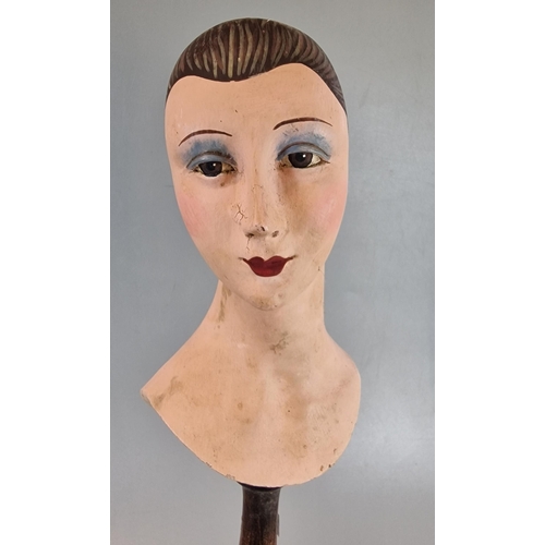 32 - Mid century composition hand painted mannequin head, now mounted on a turned wooden pedestal. 42.5cm... 