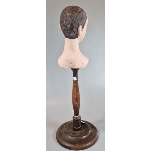 32 - Mid century composition hand painted mannequin head, now mounted on a turned wooden pedestal. 42.5cm... 