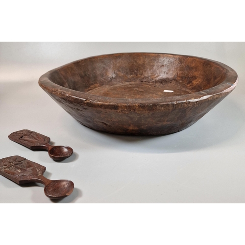 39 - Large rustic carved wooden bowl. 38cm diameter approx. together with two miniature love spoons. 15cm... 