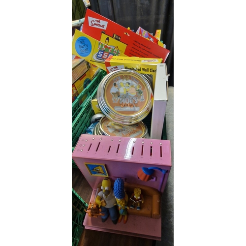 413 - Two boxes of assorted The Simpsons items to include: Topper alarm clock, Bart and Homer Simpsons ala... 