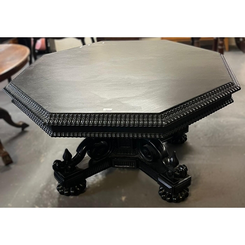 482 - 19th century stained/ebonised octagonal centre table, the base carved in ornate Oriental designs. 12... 