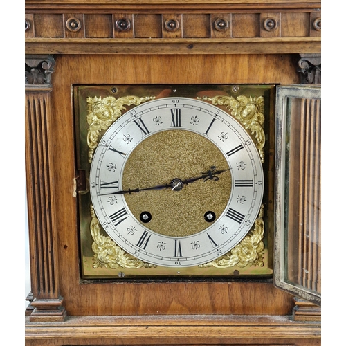 91 - Early 20th century German walnut cased architectural mantel clock with brass face, having Roman silv... 