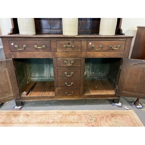 476 - Early 19th century North Wales oak dresser, the moulded cornice and boarded rack with fitted shelves... 