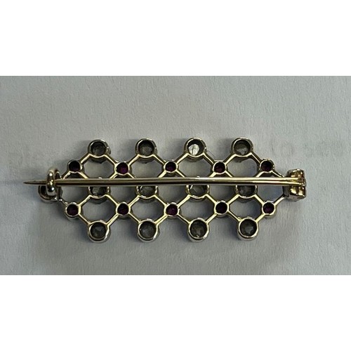 250 - White metal diamond and ruby bar brooch, featuring twenty four stones with repeating design, in leat... 