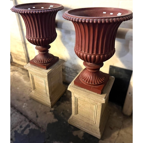 609 - Pair of cast iron fluted campana shaped pedestal vases standing on ceramic square section panel desi... 