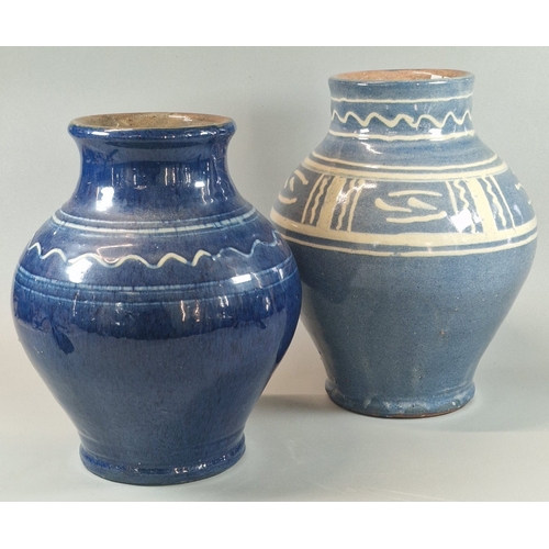 17 - Two Ewenny Clay Pits Pottery vases of baluster form on blue grounds with stylised decoration, and an... 