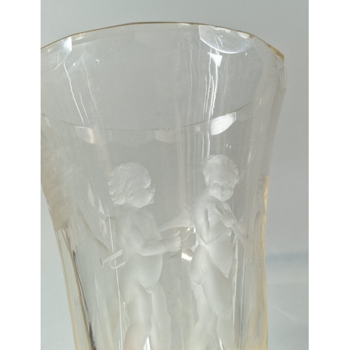 26 - Clear and frosted glass trumpet shaped goblet with flared neck and decorated overall with nude cheru... 