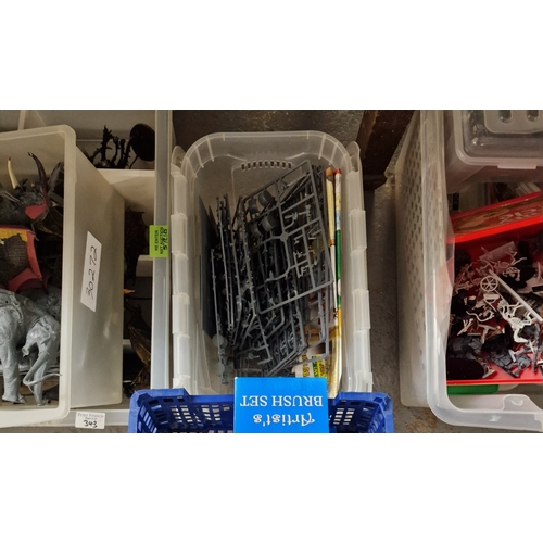 343 - Nine plastic boxes of assorted toys to include: games, Workshop Warhammer, construction kits, animal... 