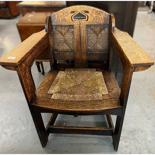 Art and Crafts pale oak armchair, with rush seat and back panels, designed by E. G. Punnett. Maker William Birch of High Wycombe, probably commissioned by Liberty of London. Height to the back 84cm approx. (B.P. 21% + VAT)