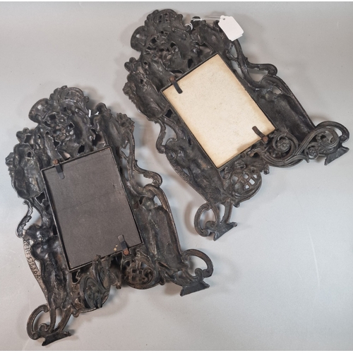 51 - Pair of cast metal copper finish easel picture frames depicting figures and cherubs. 37cm high appro... 