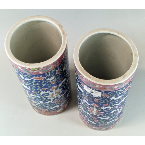 56 - Pair of Macau decorated cylindrical stoneware floral and foliate polychrome vases, six character Mac... 