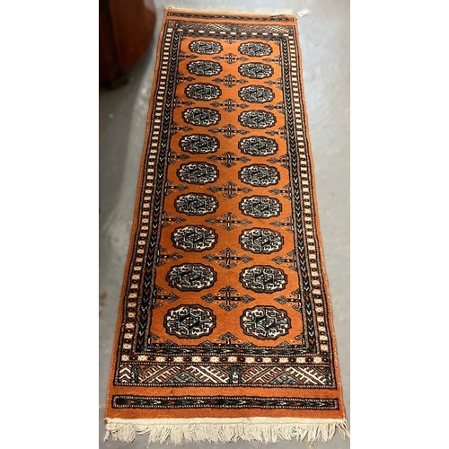 626 - Two vintage red ground Bokhara runners (probably originally one piece), together with another orange... 