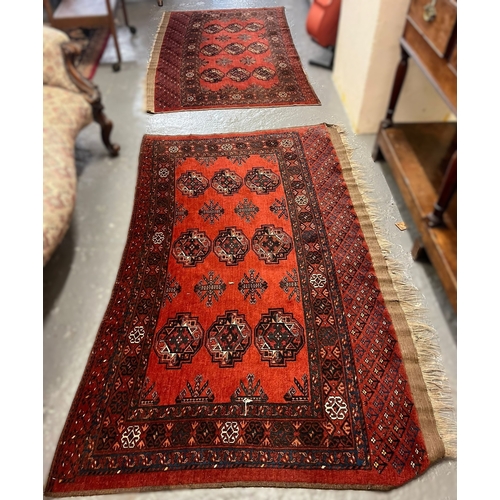 626 - Two vintage red ground Bokhara runners (probably originally one piece), together with another orange... 