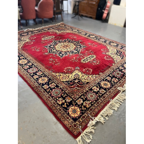 627 - Large Middle Eastern Mashad type carpet, on a red ground with central floral medallion and foliate a... 